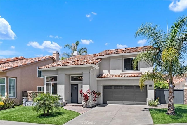 15 Surfbird Ln, Aliso Viejo, CA 92656 - mediterranean / spanish-style home featuring a tile roof, driveway, stucco siding, a chimney, and an attached garage