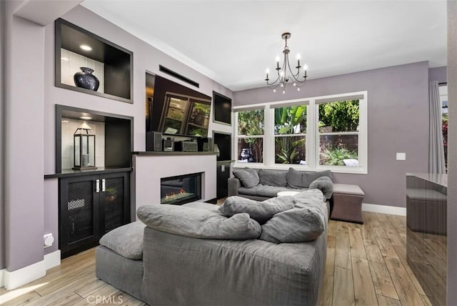 15 Surfbird Ln, Aliso Viejo, CA 92656 - living area with a chandelier, light wood finished floors, and a glass covered fireplace