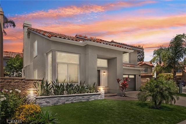 15 Surfbird Ln, Aliso Viejo, CA 92656 - mediterranean / spanish-style home featuring a tile roof, driveway, stucco siding, and an attached garage
