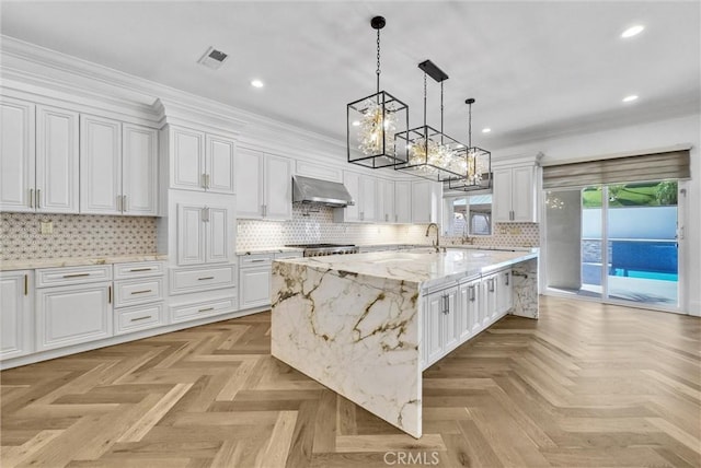 12149 Jonathan Dr, Riverside, CA 92503 - kitchen featuring ventilation hood, a chandelier, white cabinetry, recessed lighting, and tasteful backsplash