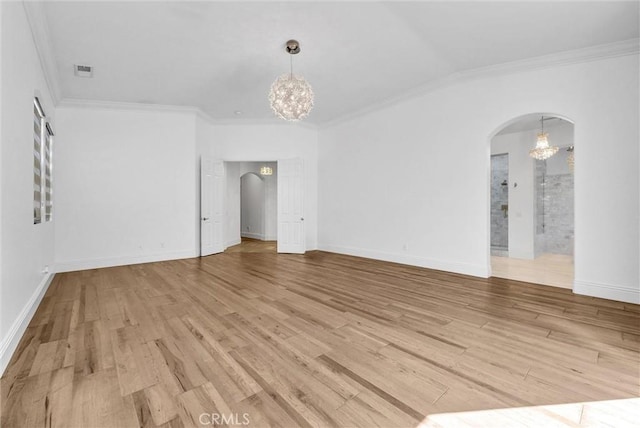 12149 Jonathan Dr, Riverside, CA 92503 - empty room featuring a chandelier, arched walkways, ornamental molding, and light wood-style floors