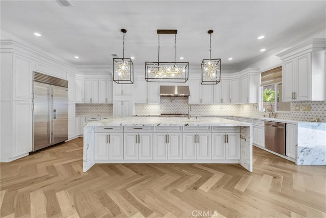 12149 Jonathan Dr, Riverside, CA 92503 - kitchen featuring appliances with stainless steel finishes, range hood, a large island with sink, white cabinets, and decorative backsplash