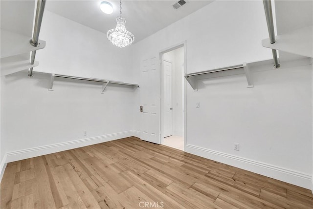 12149 Jonathan Dr, Riverside, CA 92503 - walk in closet with wood finished floors and a chandelier