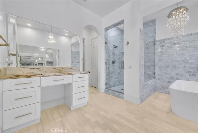 12149 Jonathan Dr, Riverside, CA 92503 - full bath featuring a shower stall, a soaking tub, vanity, wood finished floors, and recessed lighting