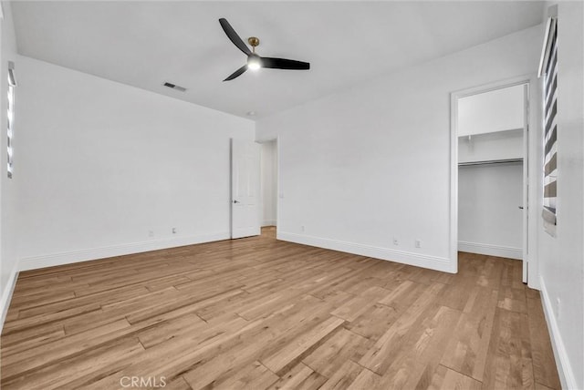 12149 Jonathan Dr, Riverside, CA 92503 - unfurnished bedroom with light wood-style flooring, a walk in closet, and ceiling fan