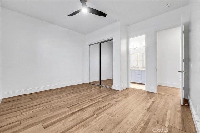 12149 Jonathan Dr, Riverside, CA 92503 - unfurnished bedroom featuring light wood-style flooring, a closet, a ceiling fan, and connected bathroom