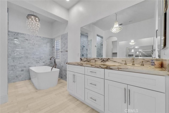 12149 Jonathan Dr, Riverside, CA 92503 - full bath with a chandelier, double vanity, a soaking tub, and walk in shower