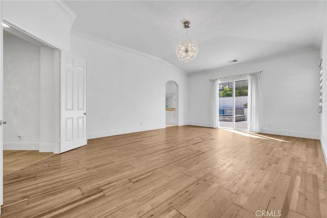 12149 Jonathan Dr, Riverside, CA 92503 - unfurnished living room featuring ornamental molding, arched walkways, light wood-style flooring, and lofted ceiling