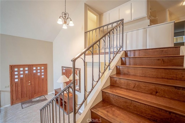 24612 Artemia Ave, Mission Viejo, CA 92691 - stairway featuring a chandelier, vaulted ceiling, and tile patterned flooring