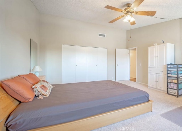 24612 Artemia Ave, Mission Viejo, CA 92691 - bedroom with light carpet, a closet, a towering ceiling, a textured ceiling, and a ceiling fan