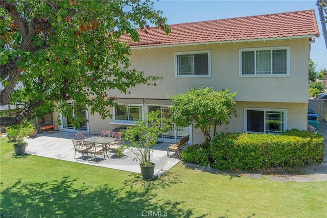 24612 Artemia Ave, Mission Viejo, CA 92691 - back of house featuring a tile roof, stucco siding, a yard, and a patio
