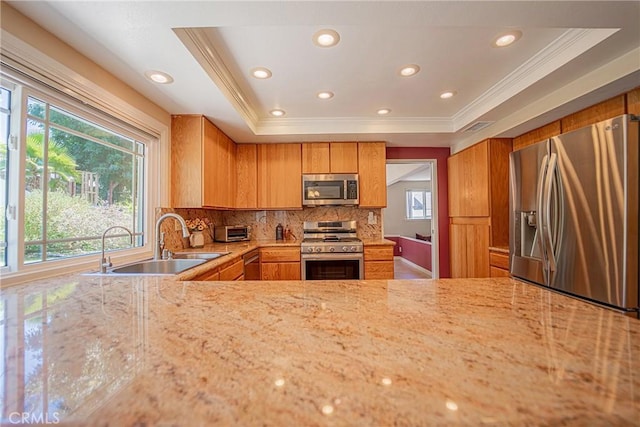 24612 Artemia Ave, Mission Viejo, CA 92691 - kitchen with appliances with stainless steel finishes, crown molding, recessed lighting, backsplash, and light stone countertops
