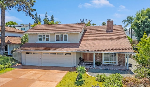 24612 Artemia Ave, Mission Viejo, CA 92691 - view of front of home featuring a tiled roof, a chimney, and driveway