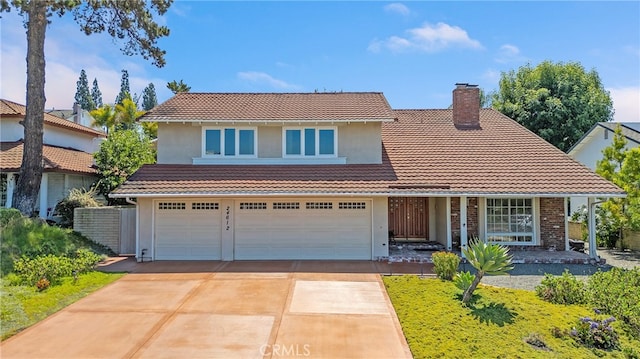 24612 Artemia Ave, Mission Viejo, CA 92691 - traditional home featuring a tiled roof, concrete driveway, a chimney, and a garage