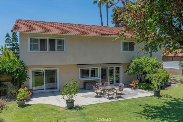 24612 Artemia Ave, Mission Viejo, CA 92691 - rear view of house featuring a tile roof, stucco siding, a lawn, and a patio