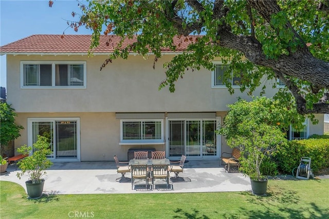 24612 Artemia Ave, Mission Viejo, CA 92691 - back of property with a patio area, stucco siding, a lawn, and a tiled roof