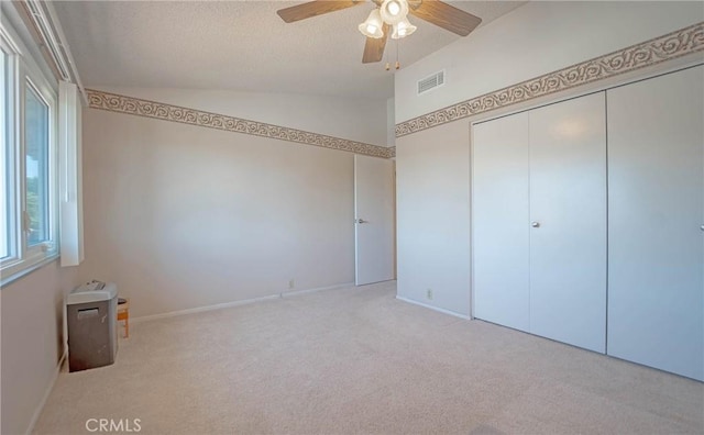24612 Artemia Ave, Mission Viejo, CA 92691 - unfurnished bedroom with vaulted ceiling, carpet floors, a closet, a textured ceiling, and ceiling fan