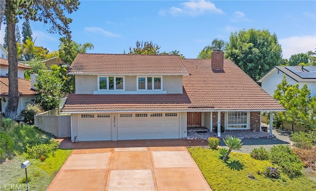 24612 Artemia Ave, Mission Viejo, CA 92691 - traditional home with a tiled roof, a chimney, concrete driveway, an attached garage, and covered porch