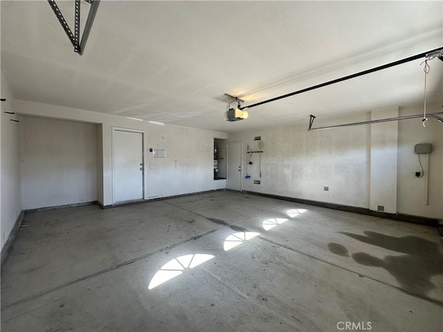 53024 Astrid Way, Lake Elsinore, CA 92532 - garage featuring baseboards and a garage door opener