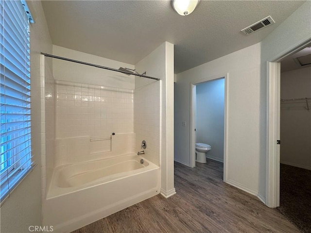 53024 Astrid Way, Lake Elsinore, CA 92532 - full bath with wood finished floors, washtub / shower combination, a textured ceiling, and a walk in closet
