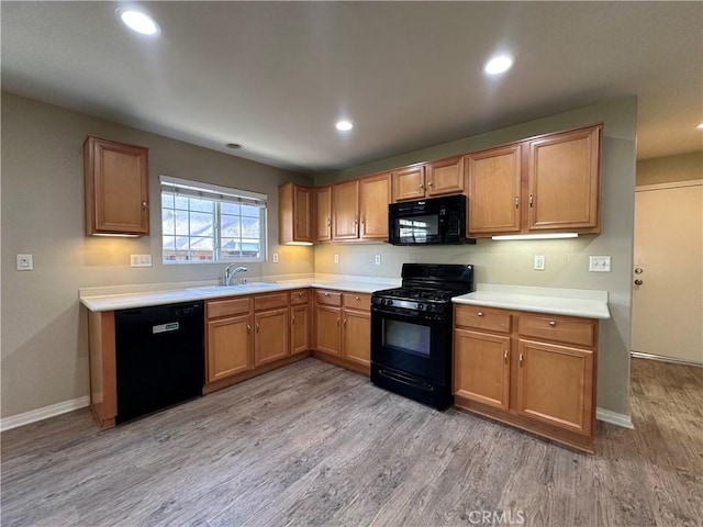 53024 Astrid Way, Lake Elsinore, CA 92532 - kitchen featuring black appliances, light wood-type flooring, light countertops, recessed lighting, and brown cabinets