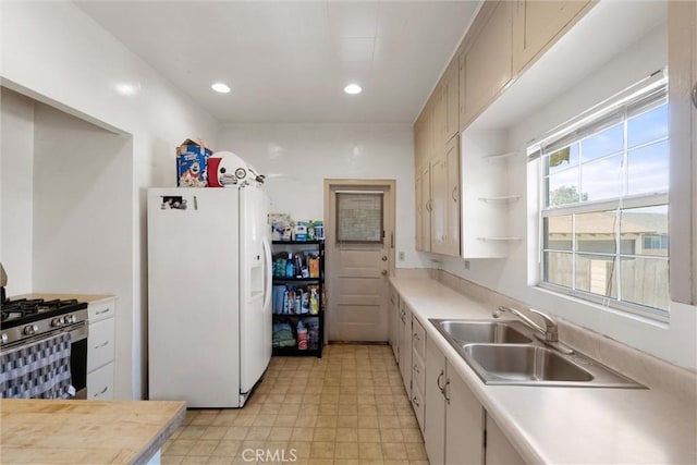 505 W Glendon Way, San Gabriel, CA 91776 - kitchen featuring white refrigerator with ice dispenser, stainless steel range with gas cooktop, light countertops, recessed lighting, and open shelves