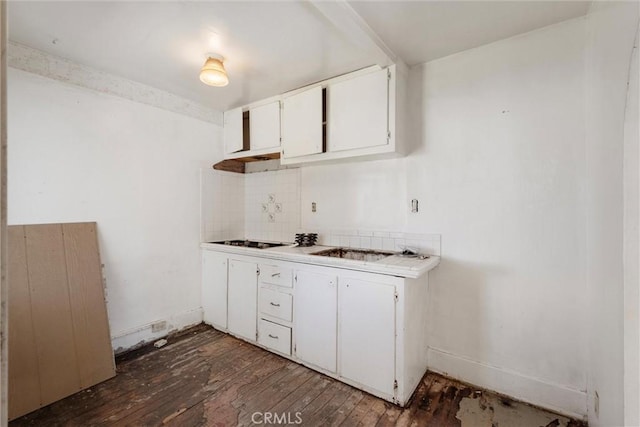 505 W Glendon Way, San Gabriel, CA 91776 - kitchen featuring dark wood-style floors, light countertops, backsplash, white cabinets, and black stovetop