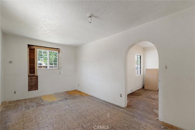 505 W Glendon Way, San Gabriel, CA 91776 - empty room with arched walkways and a textured ceiling