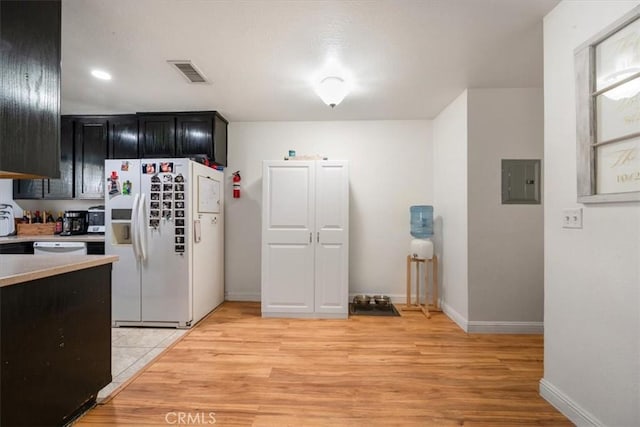 1812 Riverside Ave, Paso Robles, CA 93446 - kitchen featuring white appliances, dark cabinets, electric panel, light countertops, and light wood-style floors