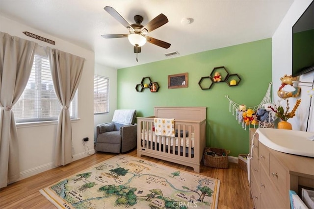 1812 Riverside Ave, Paso Robles, CA 93446 - bedroom featuring a crib, wood finished floors, and ceiling fan