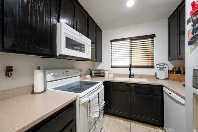 1812 Riverside Ave, Paso Robles, CA 93446 - kitchen with white appliances, dark cabinets, light tile patterned floors, and light countertops