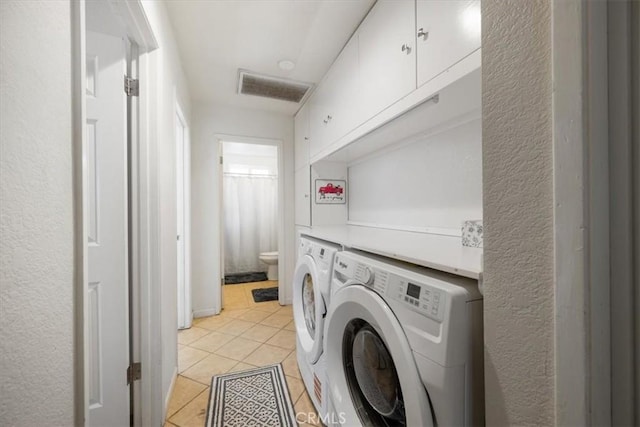 1812 Riverside Ave, Paso Robles, CA 93446 - laundry room with washer and clothes dryer, light tile patterned floors, cabinet space, and a textured wall