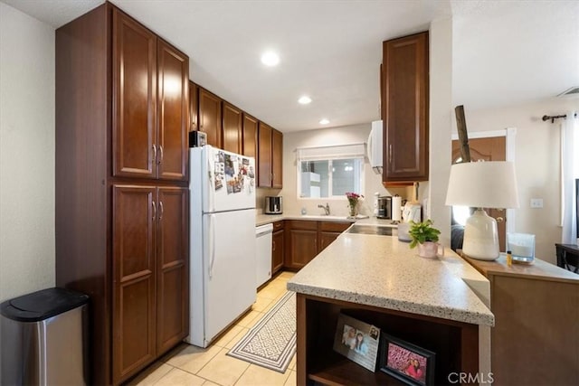 1812 Riverside Ave, Paso Robles, CA 93446 - kitchen featuring white appliances, recessed lighting, light tile patterned floors, light stone countertops, and a peninsula