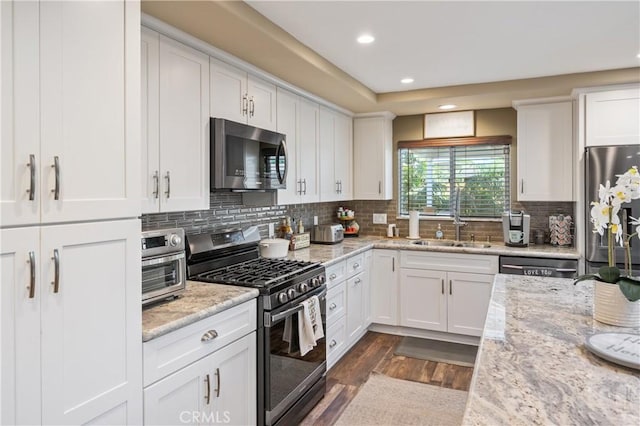 20092 E Frank Ln, Orange, CA 92869 - kitchen with stainless steel appliances, recessed lighting, dark wood-style floors, white cabinets, and backsplash