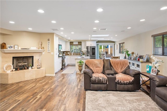 20092 E Frank Ln, Orange, CA 92869 - living room featuring light wood-type flooring, recessed lighting, and a tile fireplace