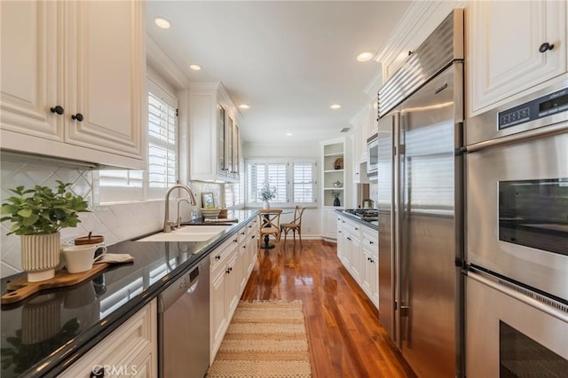 426 Via La Selva, Redondo Beach, CA 90277 - kitchen featuring built in appliances, dark countertops, dark wood-style floors, backsplash, and glass insert cabinets