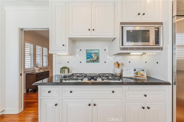 426 Via La Selva, Redondo Beach, CA 90277 - kitchen with appliances with stainless steel finishes, dark countertops, crown molding, tasteful backsplash, and white cabinets