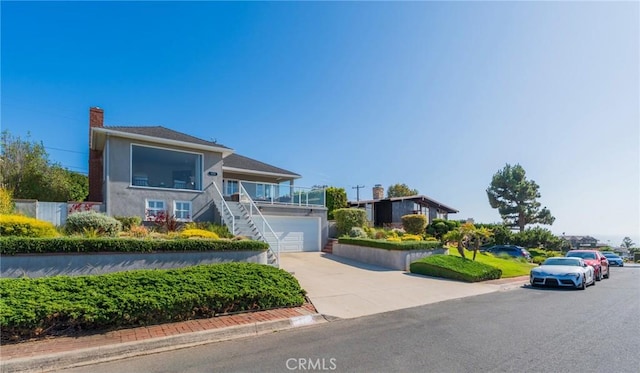 426 Via La Selva, Redondo Beach, CA 90277 - view of front of property featuring driveway, stairs, a chimney, stucco siding, and an attached garage