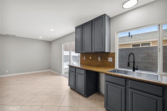 6903 Crest Ave, Riverside, CA 92503 - kitchen featuring decorative backsplash, gray cabinets, and recessed lighting