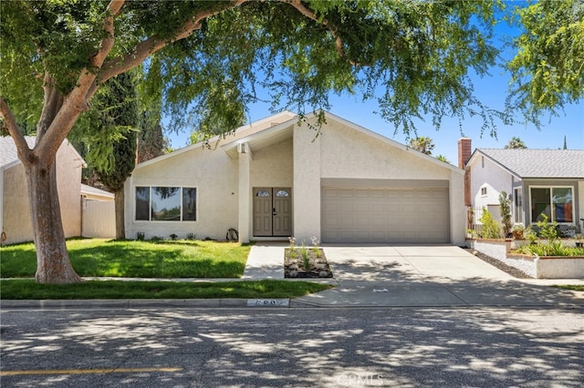 6903 Crest Ave, Riverside, CA 92503 - view of front facade with a garage, stucco siding, concrete driveway, and a chimney