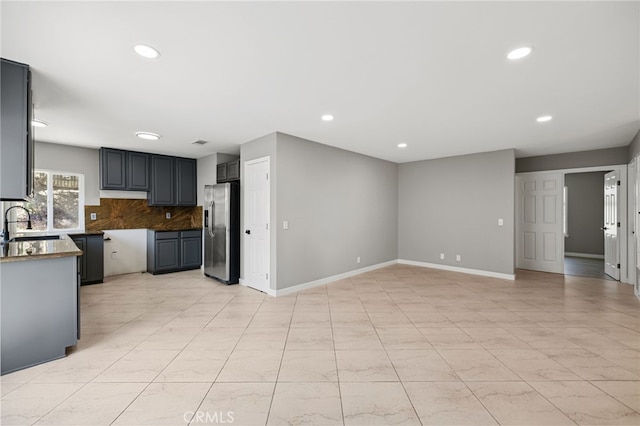 6903 Crest Ave, Riverside, CA 92503 - kitchen with stainless steel fridge, recessed lighting, decorative backsplash, and under cabinet range hood