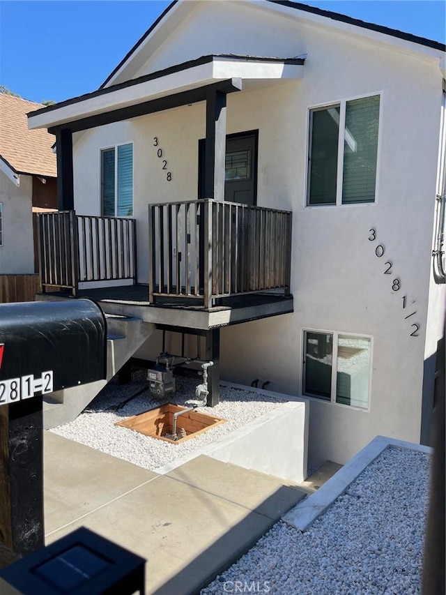 3028 E 1st St, Los Angeles, CA 90063 - view of front of property with stucco siding and a porch