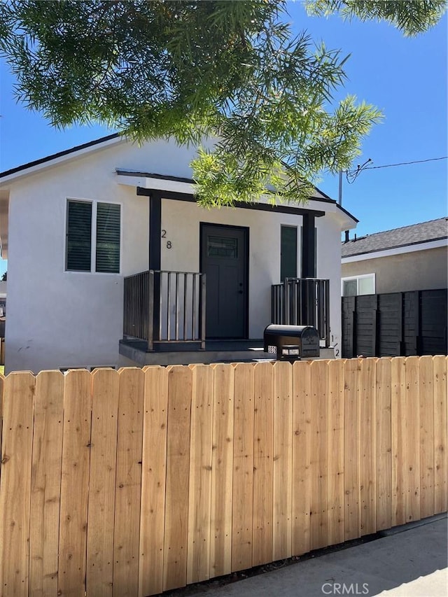 3028 E 1st St, Los Angeles, CA 90063 - bungalow featuring stucco siding, a balcony, and a gate