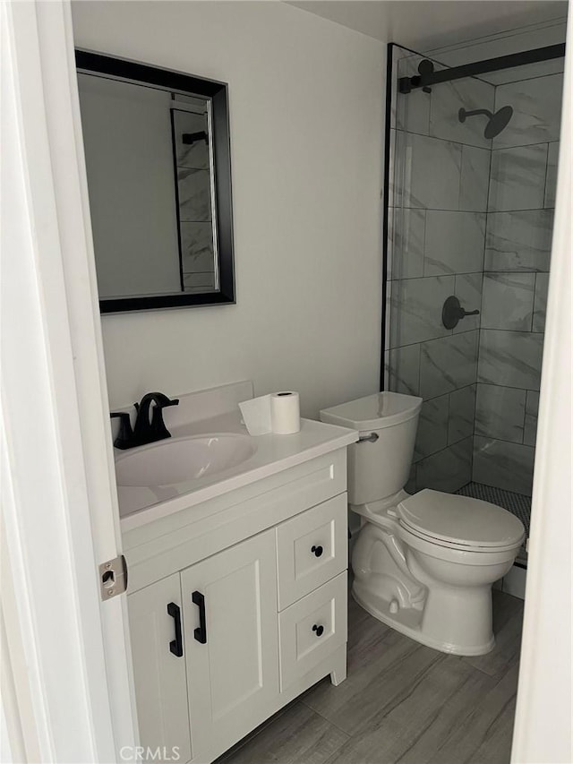 3028 E 1st St, Los Angeles, CA 90063 - full bathroom featuring vanity, tiled shower, and wood finished floors