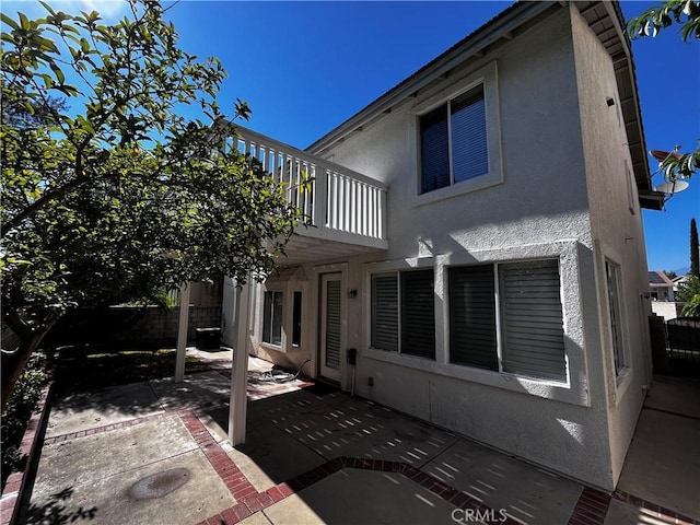 16340 Willowmist Ct, Chino Hills, CA 91709 - rear view of house featuring stucco siding, a balcony, and a patio