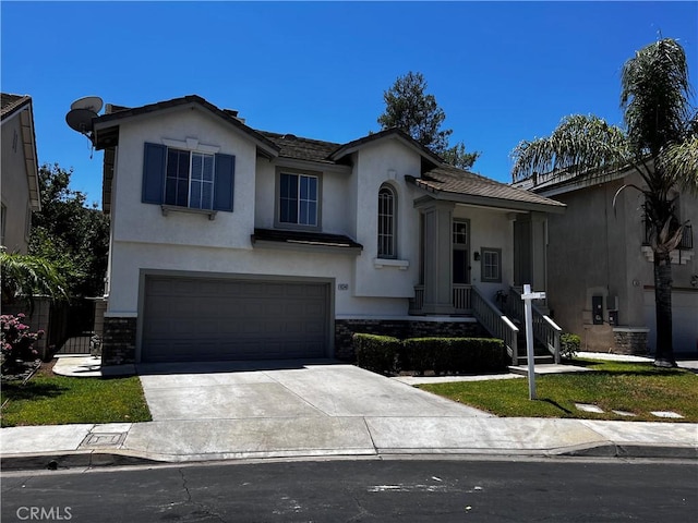 16340 Willowmist Ct, Chino Hills, CA 91709 - view of front facade with concrete driveway, a garage, stucco siding, and stone siding
