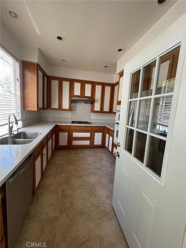 16340 Willowmist Ct, Chino Hills, CA 91709 - kitchen featuring gas cooktop, dishwasher, light countertops, glass insert cabinets, and under cabinet range hood