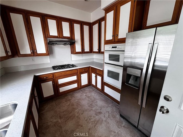 16340 Willowmist Ct, Chino Hills, CA 91709 - kitchen featuring appliances with stainless steel finishes, light countertops, under cabinet range hood, and glass insert cabinets