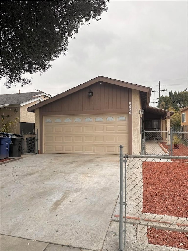 9620 San Vincente Ave, South Gate, CA 90280 - view of front of house featuring a gate, a garage, driveway, and stucco siding