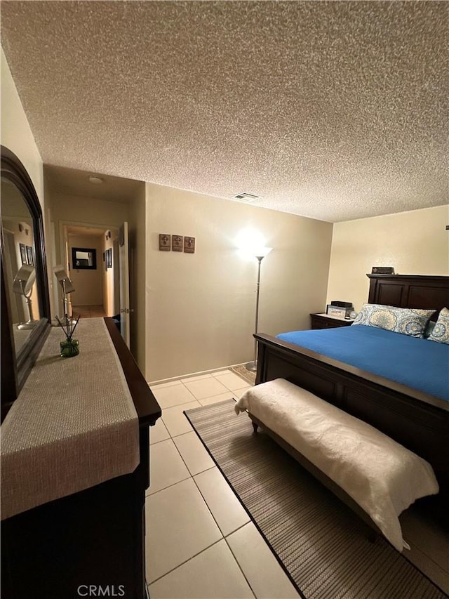 9620 San Vincente Ave, South Gate, CA 90280 - bedroom featuring a textured ceiling and light tile patterned flooring